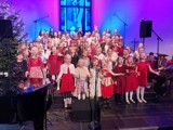 Bilde viser Hommersåk skolekor synge julekonsert i en kirke.